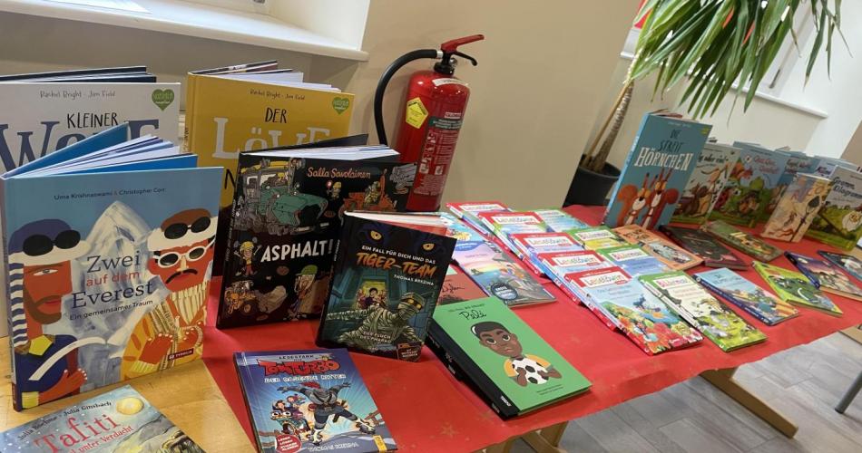 Verschiende Kinderbücher zum Schmökern werden auf Tischen präsentiert.